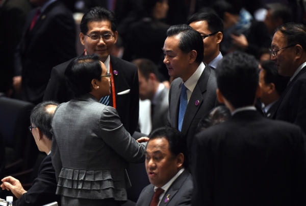 China’s Foreign Minister Wang Yi (center R) shakes hands with Indonesia’s Foreign Minister Retno Marsudi (front L) during the Asia-Pacific Economic Cooperation (APEC) Summit at the China National Convention Centre (CNCC) on November 7, 2014 in Beijing, China. (Greg Baker/Getty Images)