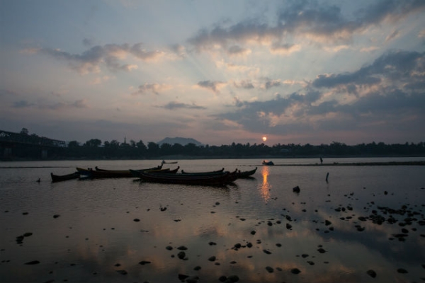 A fisherman at sunset on the Irrawaddy River in northern Myanmar on December 28, 2013. (Diana Markosian/Getty Images)