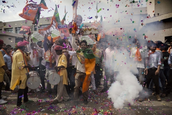 BJP supporters dance as they set off crackers as poll results come in at the party's headquarters on May 16, 2014 in Ahmedabad, India. Early indications from the Indian election results show Mr Modi's Bharatiya Janata Party was ahead in 277 of India's 543 constituencies where over 550 million votes were made, making it the largest election in history. (Kevin Frayer/Getty Images)