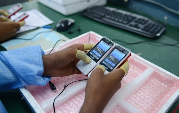 n Indian technician checks mobile phones at the Chinese Celkon Manufacturing plant at Medchal Mandal in the Rangareddy district on the outskirts of Hyderabad on June 26, 2015. (Noah Seelam/AFP/Getty Images)