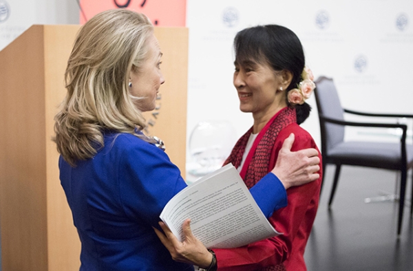 Then Secretary of State Hillary Clinton (L) greets Aung San Suu Kyi before the Myanmar parliamentarian spoke at an event co-hosted by Asia Society and the U.S. Institute of Peace in Washington, D.C. on September 18, 2012. (Asia Society/Joshua Roberts)