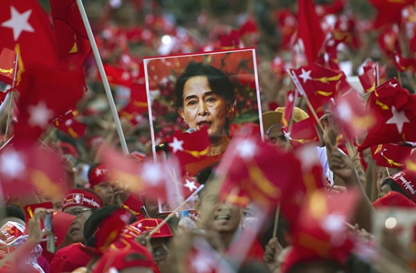 Supporters of Aung San Suu Kyi hold posters bearing her image as they listen to her speak during a campaign rally for the National League for Democracy in Yangon on November 1, 2015. (Ye Aung Thu/AFP/Getty Images)
