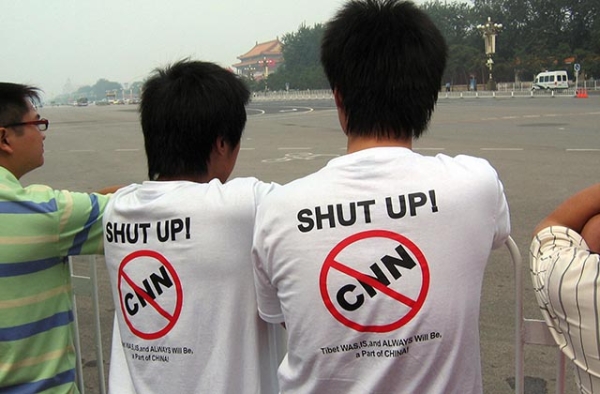 Two Chinese protesters wear anti-CNN t-shirts on Tiananmen Square in Beijing on August 8, 2008. (Robert Saiget/AFP/Getty Images)
