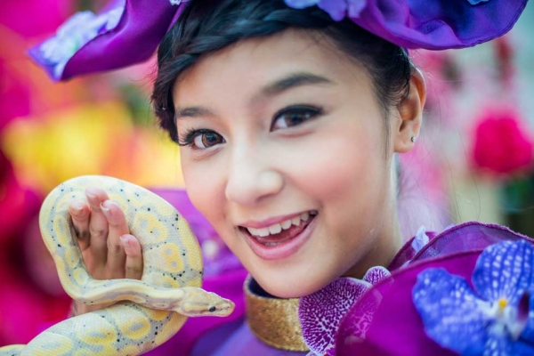 A model poses with a snake during a snake display to promote responsible breeding and pet ownership in Hong Kong on January 10, 2013. (Philippe Lopez/AFP/Getty Images)
