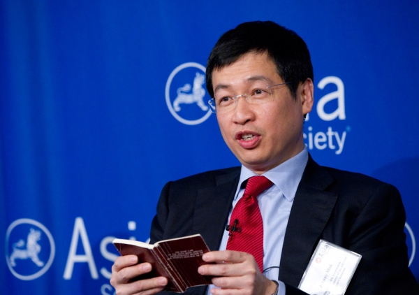 Johnny Mok, Senior Counsel for Hong Kong SAR, references a pocket-sized version of the Basic Law during a June 27, 2014 lunch at Asia Society New York. (Elena Olivo/Asia Society)