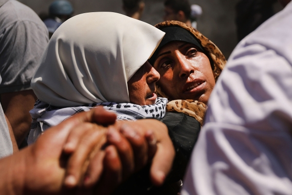A wounded Palestinian women is carried from the border fence with Israel 
