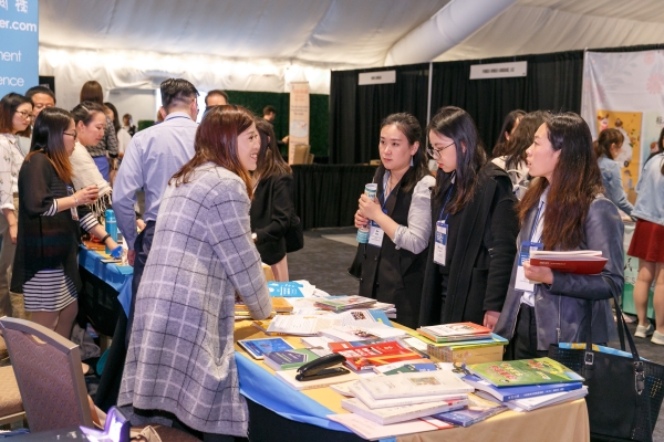 2019 National Chinese Language Conference participants chat in the conference exhibit hall 1