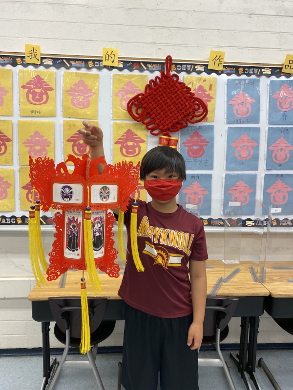 Third-grader assembling the Chinese lantern on the Lantern Festival day