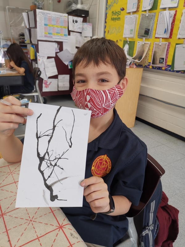 Second-grader drawing the Chinese traditional painting with Chinese brush in the Chinese culture class