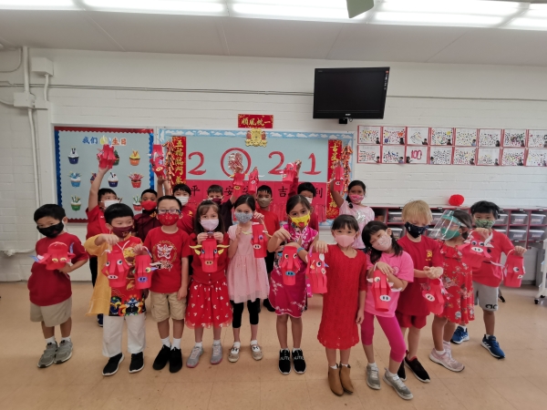 First-graders holding Chinese lanterns in the classroom