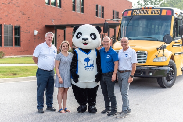 School leadership poses with mascot Ming Ming