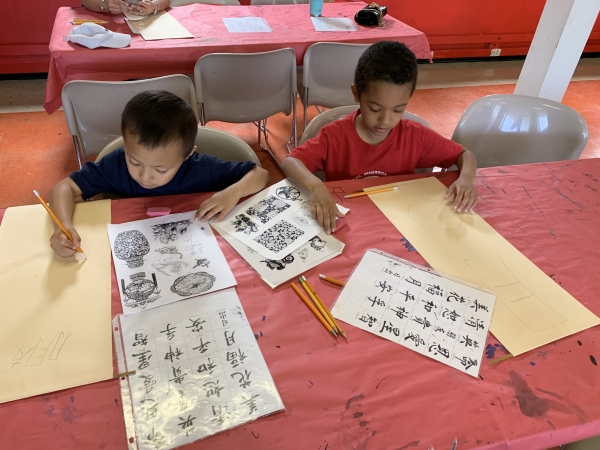 Students enjoying Chinese art and calligraphy