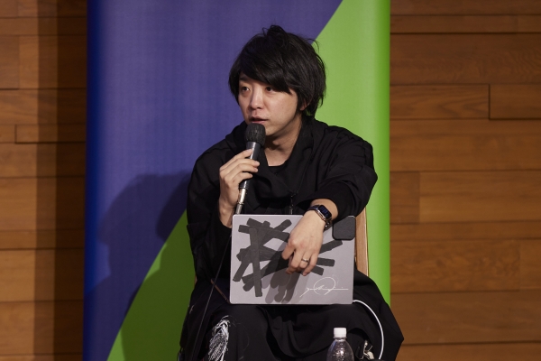 Yoichi Ochiai speaking in the panel discussion