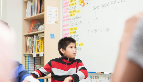 5th grade student listening to instructions from the teacher for an assignment. (Ann-Marie VanTassell Photography)