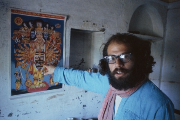 BENARES, INDIA - FEBRUARY 1963: Ginsberg points at a poster in his apartment near the banks of the Ganges. (Pete Turner/Getty Images)