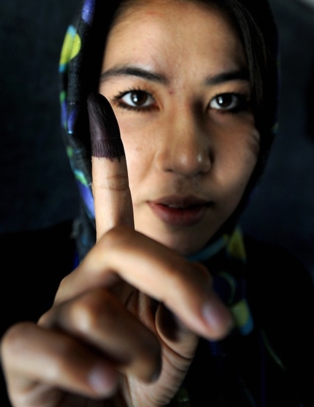 A woman displays her finger marked with indelible ink after casting her vote at a polling station in Kabul on August 20, 2009. (Shah Marai/AFP/Getty Images)