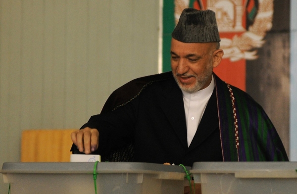 President Hamid Karzai votes at a boys&apos; high school in Kabul on August 20. Karzai&apos;s team was confident he would have 50% of the vote, enough to avoid a runoff. (Shah MaraiAFP/Getty Images)