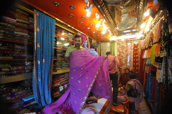A Bangladeshi salesman displays saris at a textile shop during Ramadan in 2009. Ramadan is the Muslim majority nation&apos;s busiest time for retail sales with clothes the most popular item given during Eid-ul-Fitr, which marks the end of Ramadan. (Munir Uz Zaman/AFP/Getty Images)