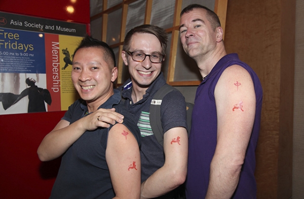Guests show off their Asia Society tattoos. (Ellen Wallop/Asia Society)