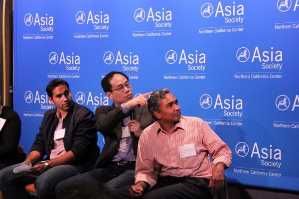 Ping Yeh, a Contributor to g0v.tw, elaborates on a slide while Rizqi and Srinivasan observe. (Asia Society)