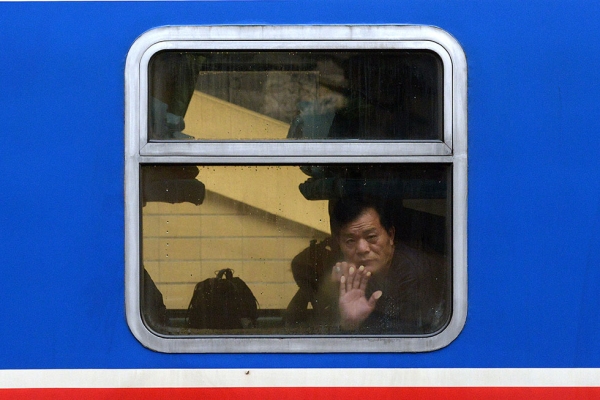 A man looks out of a crowded train on January 23, 2014 in Beijing, China. (Wang Zhao/AFP/Getty Images)