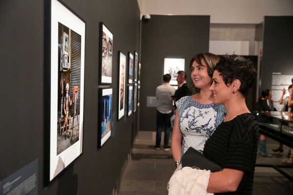  Two guests look at one of the many evocative images on display.