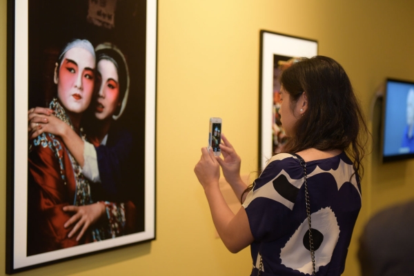 A guest takes a photo of an exhibit with her smartphone.