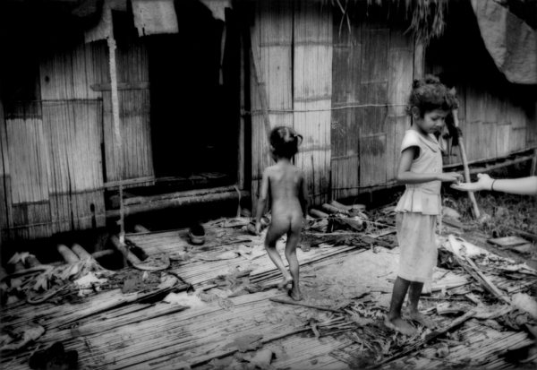 Batek Negrito girls living in poor conditions in the settlement built by the government to lure them out of the rainforest. (James Whitlow Delano) 