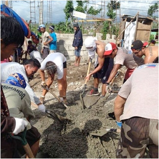 Gawad Kalinga’s volunteers working with locals to help rebuild homes