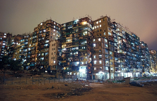 Lights illuminate the Kowloon Walled City at night. Originally a Chinese fort, the Walled City became a crowded residential dwelling after the British occupation of Hong Kong, and was ultimately demolished in 1993. (Greg Girard)