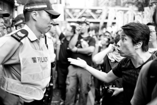 Demonstrator squaring off against the police at CY Leung's inauguration as Hong Kong's new Chief Executive on July 1, 2012. (Ding Yuin Shan/flickr)