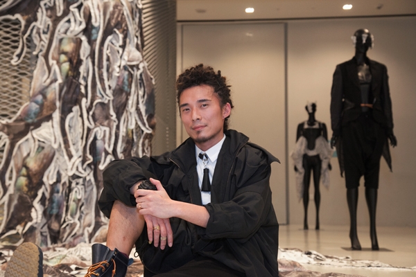 Hong-Kong-based designer Yeung Chin in front of his artworks. 