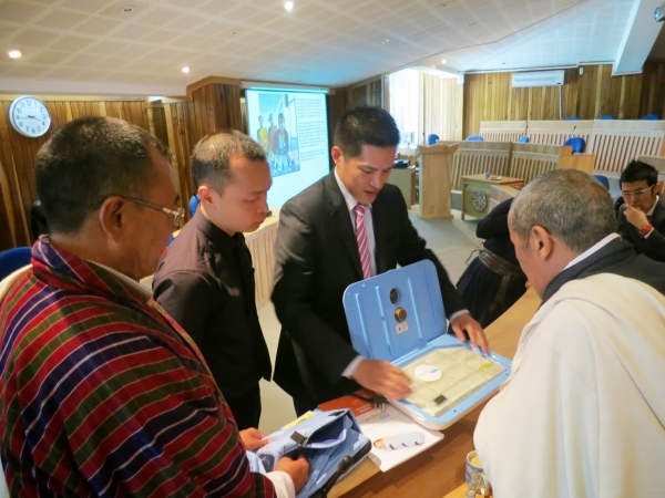 Eric Wong demonstrating the Accutemp Heater and WarmPak  to the Secretary and Director General (left), Ministry of Health, Bhutan