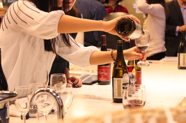 Asia Society volunteers pour glasses of Treaty Port Vineyards wine (Ranna Iglesias Asia Society).