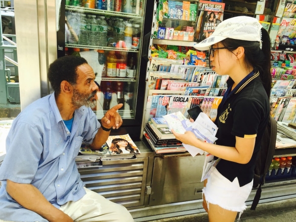 Young Scholar Liang Qiqi (right) asks a street vendor (left) for directions during the New York City Scavenger Hunt. (Zhangbolong Liu & Zhu Xi/New York)