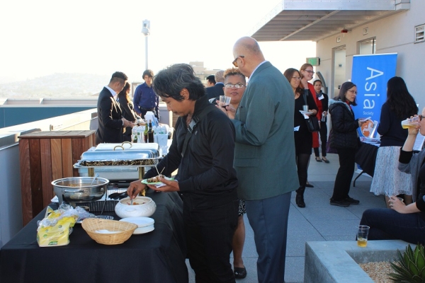Open House guests enjoy the chicken sate donated by The Consulate General of Indonesia at the reception (Stesha Marcon Asia Society).