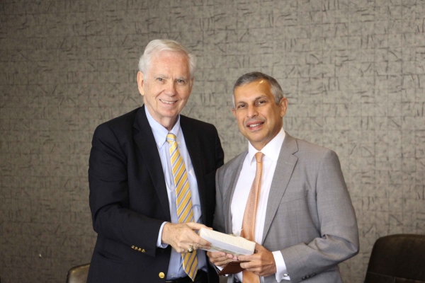 Asia Society Texas Center board member Charles Foster presents Ambassador Mirpuri with a gift. (Asia Society Texas Center - Paul Pass)