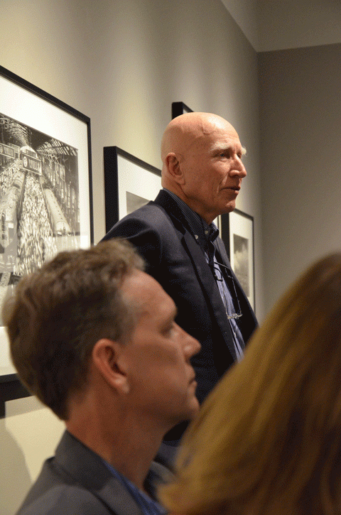 Sebastiao Salgado speaks in front of his famous image of Churchgate Train Station at a June 4 ASSC dinner at the Peter Fetterman Gallery.