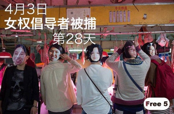 Masked activists pose at a market.