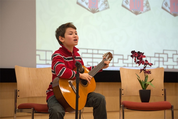 Contestant from Champion Learning Academy performing a Chinese poem "Lan Hua Cao" with guitar. (North Carolina Public Schools)