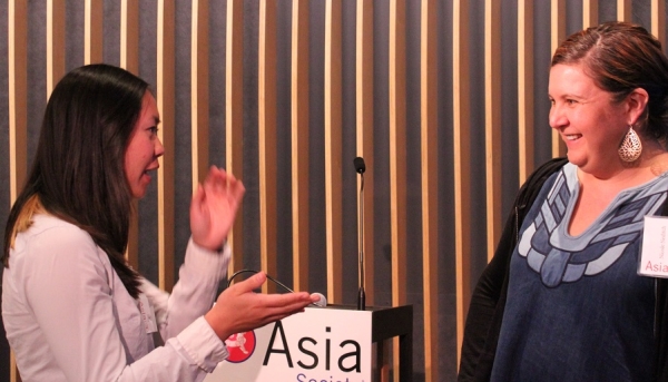 Neditch (right) has an amusing conversation with an attendee. (Asia Society)
