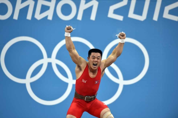 GOLD: North Korea's Kim Un Guk celebrates his new world record during the weightlifting men's 62kg group A event on July 30, 2012. (Yuri Cortez/AFP/GettyImages)