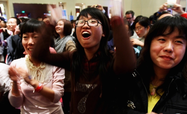 Women at an election watch party in Beijing, China react after the announcement of Barack Obama&apos;s win over John McCain on November 5, 2008. (Guang Niu/Getty Images)