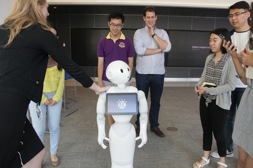 The Young Scholars admire Pepper, the robot powered by IBM Watson cognitive computing technology, in New York. (Jenny Xu)