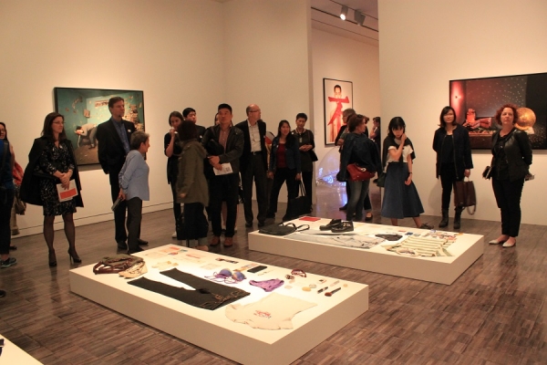 Members gathered around Liu Chuang's artwork, Buying Everything on You (2009). (Asia Society)