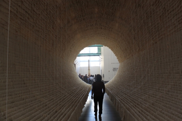 A member walking inside Zhu Jinshi's Boat (2012) made with xuan paper, bamboo and cotton thread. (Asia Society)