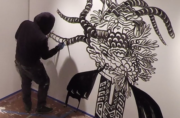 Eko Nugroho paints a mural at Asia Society Museum in New York. (Salvador Pantoja/Asia Society)
