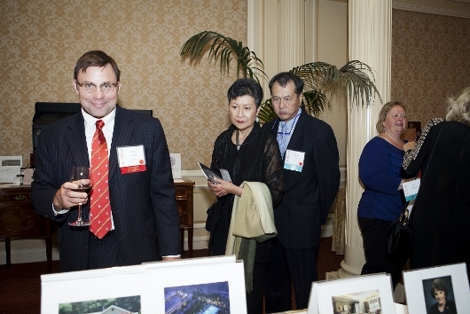 ASNC Advisory Board member Erich Friess and Linda and David Lei admire items available at the dinner's silent auction (Whitney Legge Photography)