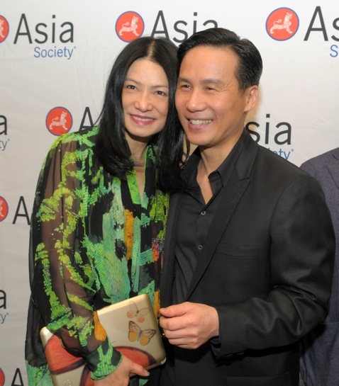 Vivienne Tam, shown holding her trademark HP butterfly clutch, with actor BD Wong. (Elsa Ruiz/Asia Society)