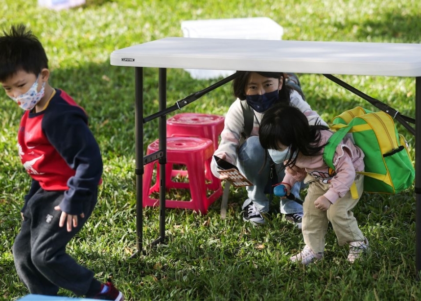 Children practice carrying first aid kits while negotiating obstacles on roads during an event held by Taiwanese civil defense organization Kuma Academy, in New Taipei City on November 18, 2023, to raise awareness of natural disaster and war preparedness. 